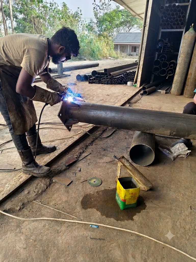 Krushna Tensile craftsman welding a steel structural column in the workshop